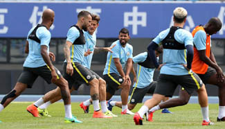 Players of Manchester City take part in training session in Beijing