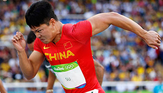 China's Xie Zhenye, Zhang Peimeng compete during men's 100m at Olympic Games