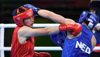 China's Li Qian competes against Nouchka Fontijn at women's middle semifinal of Boxing
