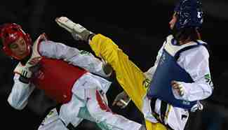 Zheng Shuyin competes against Walkden at women's +67kg semifinal of Taekwondo