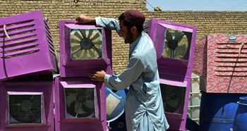 Technician makes room air-cooler in Pakistan