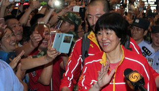 Chinese athletes arrive home