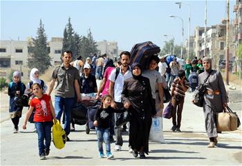 Nearly 300 Syrian civilians evacuated from rebel-held town in Damascus
