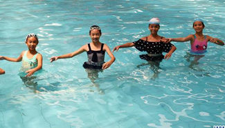 Girls perform dancing in swimming pool in S China