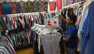 Customers choose clothes at local marketplace in Cairo
