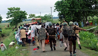 Indian policemen expel illegal settlers near Kaziranga National Park
