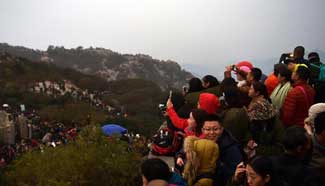 People enjoy views on Taishan Mountain