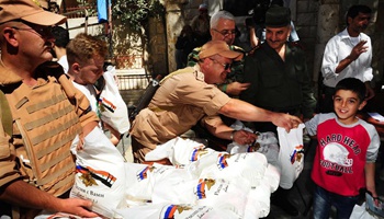 Russian soldiers distribute aid to afflicted Syrians near Damascus