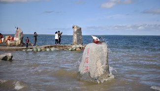 Tourists view Qinghai Lake in northwest China's Qinghai