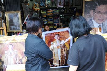 Thailand witness boom in sales of late Thai King's portraits