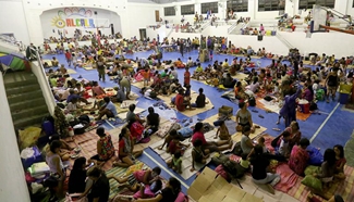 Evacuees take shelter as Typhoon Haima approaches Philippines