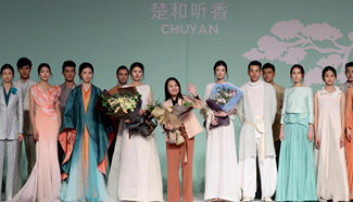 Models present creations by designer Chu Yan during China Fashion Week