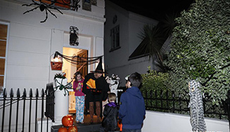 Kids play "Trick or Treat" at Halloween in London, Britain