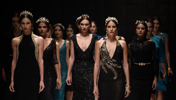 Models present dress creations in Int'l Wedding and Evening Dress Week