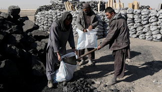 Afghan labors work at coal market in Kabul