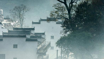 Village shrouded by morning mist in E China's Wuyuan County