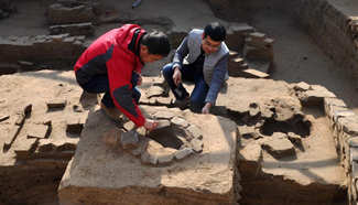 Staff members work at ruins of Haifeng Town in N China