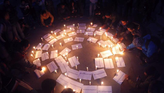 People participate in candle light vigil for plane crash victims in Colombia