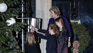British PM lights Downing Street Christmas tree with local children
