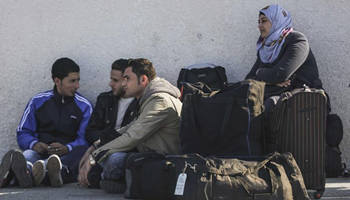 Palestinians wait to cross into Egypt through Rafah Border Crossing