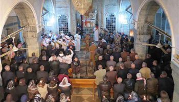 People gather in Iraq's Bartella to attend Christmas Mass