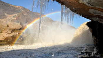 Rainbow arches over Hukou Waterfalls on Yellow River in N China