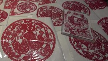 Chinese artists make papercut roosters to celebrate new year