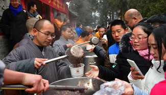 People get free Laba porridge at Shaolin Temple in central China