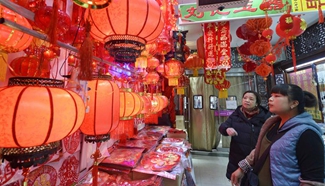 People buy Lunar New Year decorations at market in Yinchuan, NW China