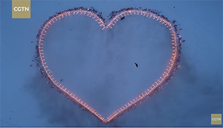 Astonishing: French skiers form giant heart for astronaut