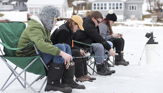 People take part in free ice fishing event in Otsego County, U.S.