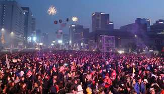Spotlight: South Koreans celebrate Park's ouster in last, festive candlelight rally