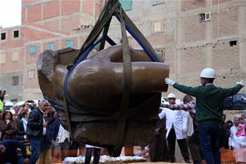 Parts of statue lifted at site of new archeological discovery in Cairo
