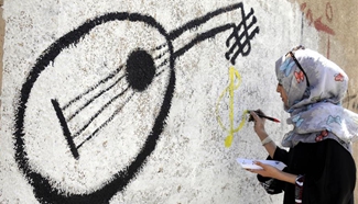 People paint graffiti to express wishes for peace in Sanaa, Yemen