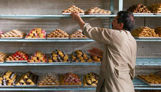 Afghan men work at cake factory in Herat