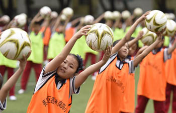 Students do football exercises in Hohhot, N China's Inner Mongolia