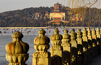 People have fun on ice rink in Beijing's Summer Palace