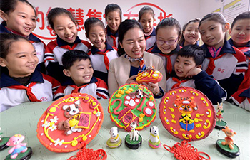Students make dough sculptures to greet upcoming Spring Festival in N China