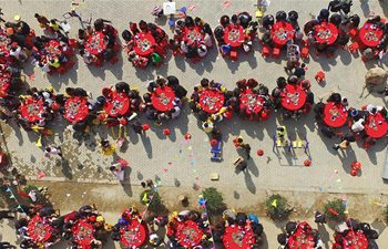 Villagers gather together at feast to celebrate Spring Festival in E China