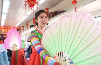 Attendants perform for passengers on train to celebrate Spring Festival