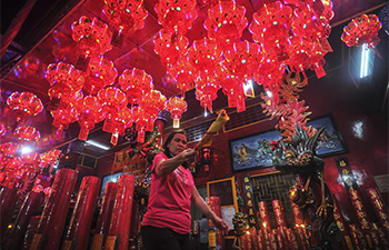 People light incense and pray before Chinese Lunar New Year in Jakarta
