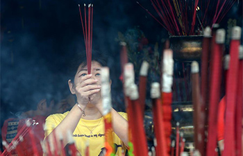People pray during Chinese Lunar New Year celebrations in Tangerang, Indonesia