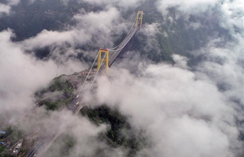 Bridge enveloped by clouds and fog in Enshi, central China's Hubei