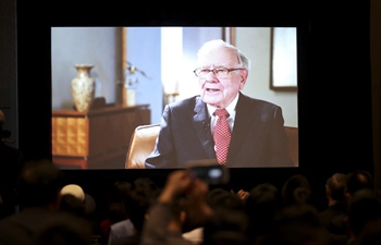 Participants watch video of interview of Buffett in Omaha, U.S.