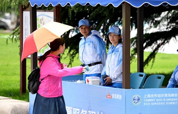 Volunteers seen on street in host city of 18th SCO Qingdao Summit