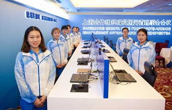 Volunteers work at registration center for 18th SCO summit in Qingdao