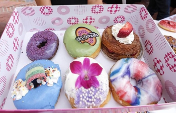 Variety of donuts displayed at DTLA Donut Festival in Los Angeles