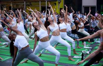 People participate in free yoga class to celebrate solstice in New York