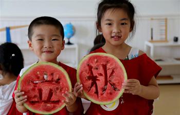 Children eat watermelons to celebrate coming of autumn across China