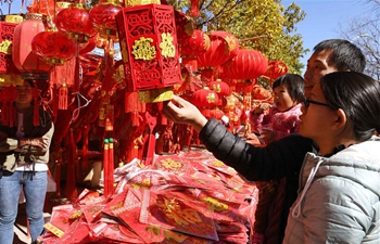 People buy Spring Festival decorations at local market in SW China's Yunnan